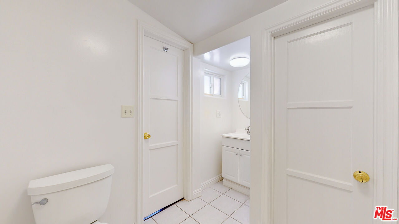 7865 Denivelle Road Sunland, CA 91040 - Photo 36 of 54 a bathroom with a sink and mirror with toilet