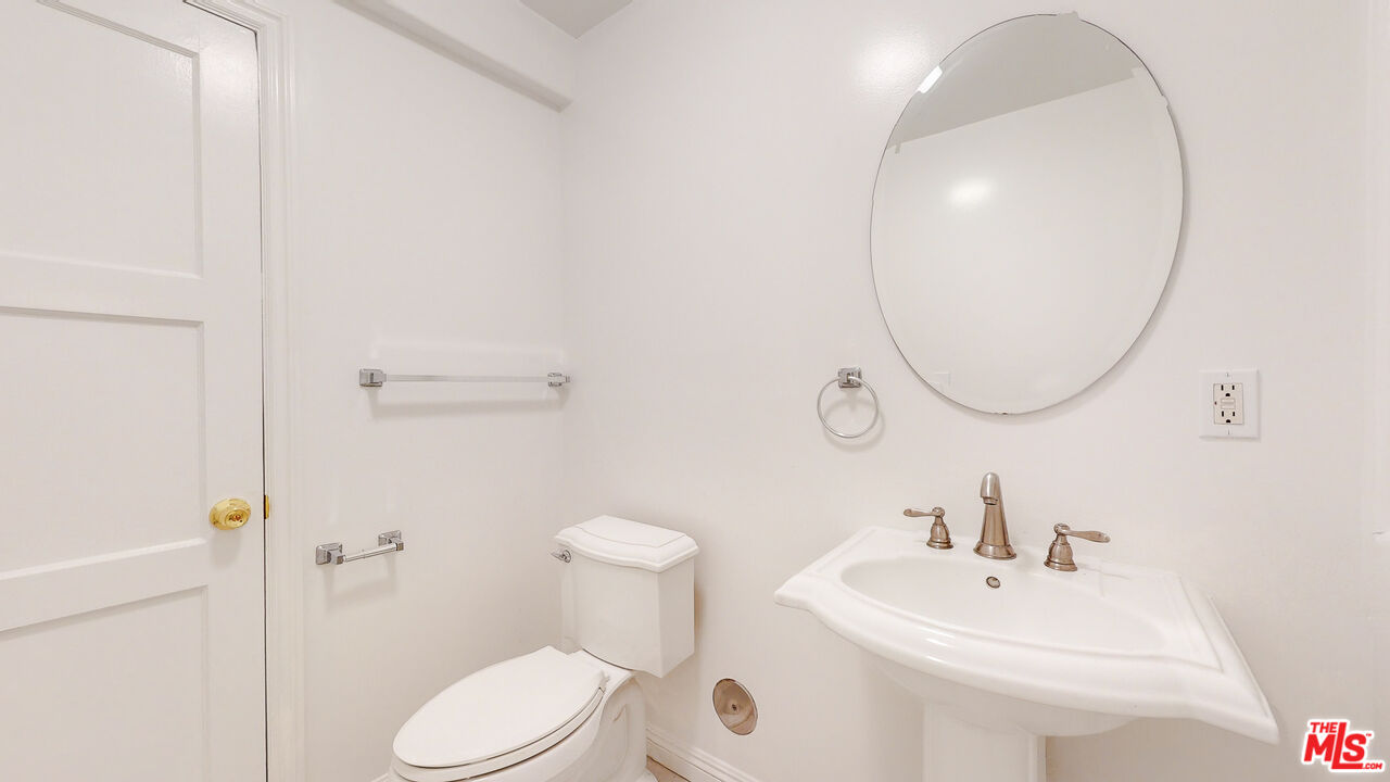 7865 Denivelle Road Sunland, CA 91040 - Photo 38 of 54 a bathroom with a sink a toilet and a mirror