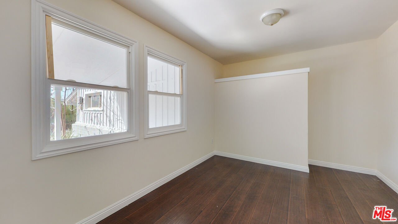 7865 Denivelle Road Sunland, CA 91040 - Photo 39 of 54 an empty room with wooden floor and windows