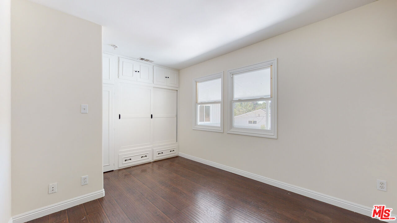 7865 Denivelle Road Sunland, CA 91040 - Photo 41 of 54 an empty room with wooden floor and window