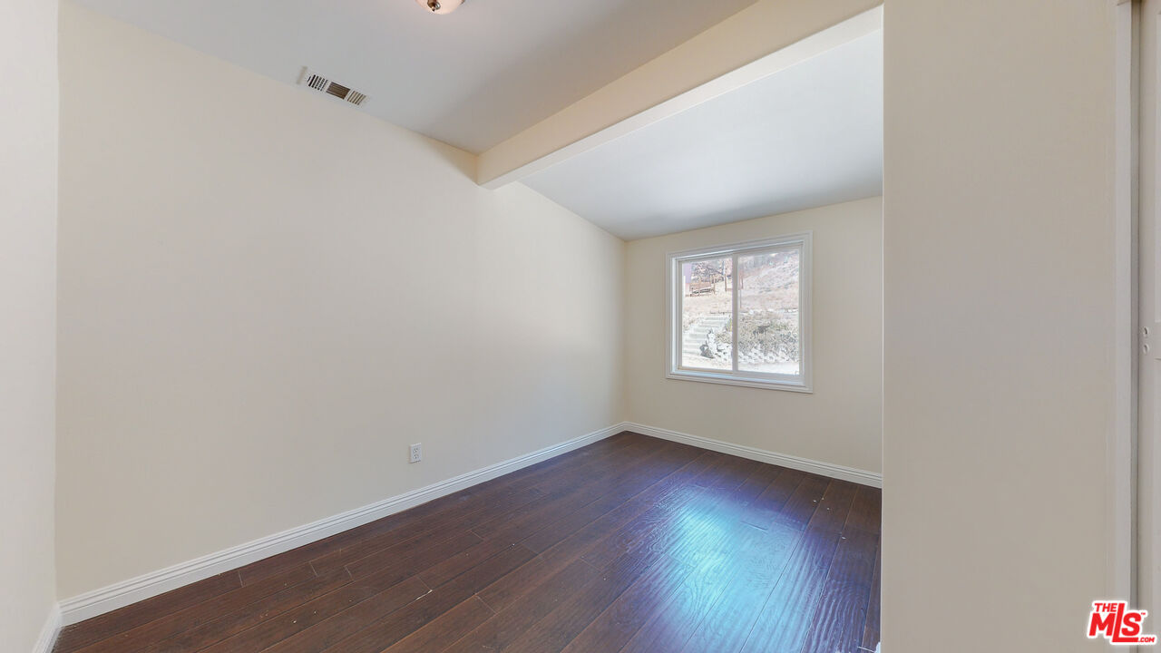 7865 Denivelle Road Sunland, CA 91040 - Photo 43 of 54 a view of an empty room with wooden floor and a window