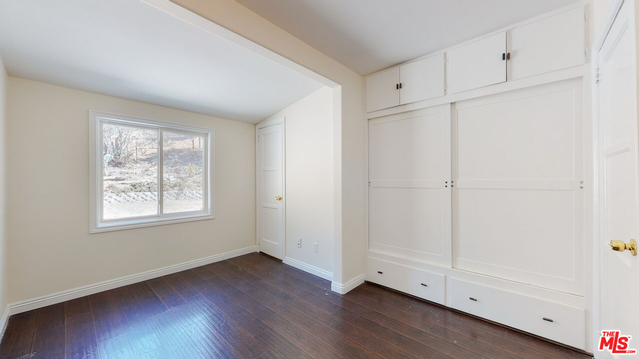 7865 Denivelle Road Sunland, CA 91040 - Photo 44 of 54 a view of an empty room with wooden floor and a window