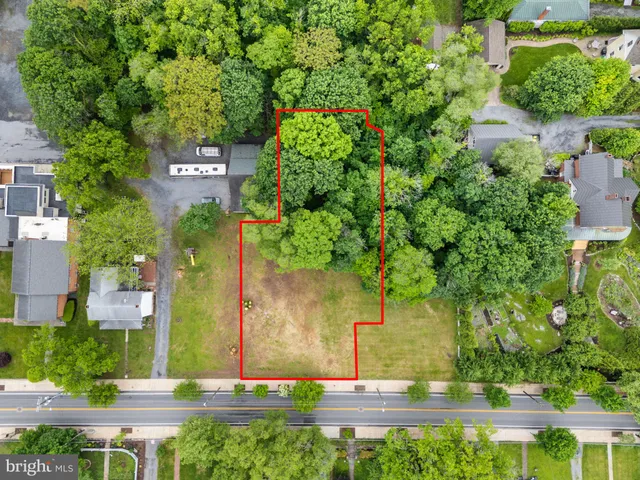 a sign that is sitting in front of flowers