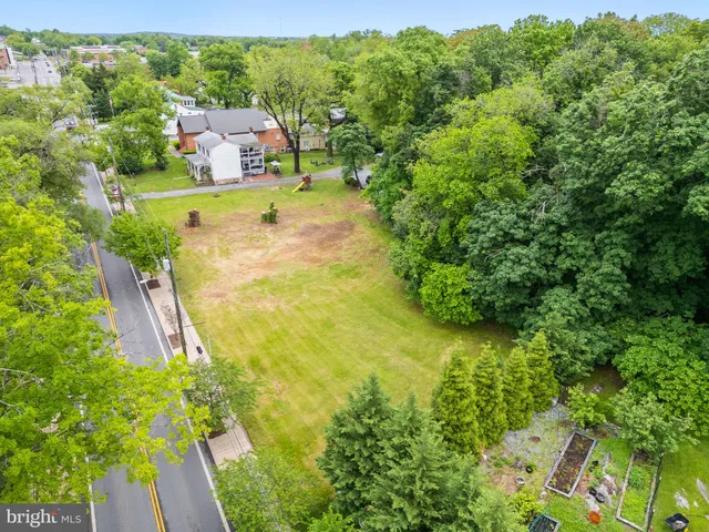 an aerial view of residential house with an outdoor space and seating