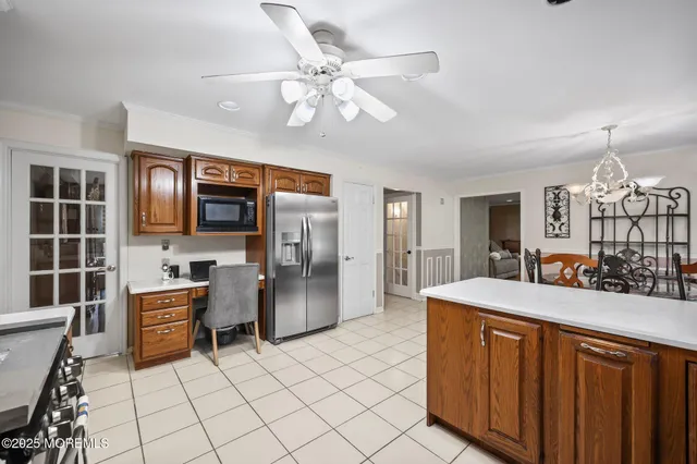 a kitchen with stainless steel appliances a table and chairs in it