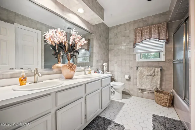 a bathroom with a double vanity sink and a mirror