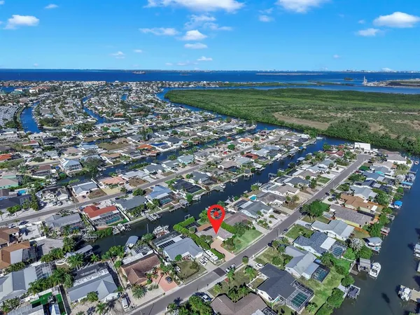 a kitchen with granite countertop a refrigerator a stove a sink a dining table and chairs