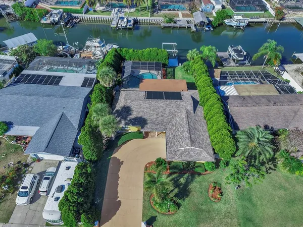 a kitchen with stainless steel appliances granite countertop a refrigerator a stove top oven with a dining table and chairs