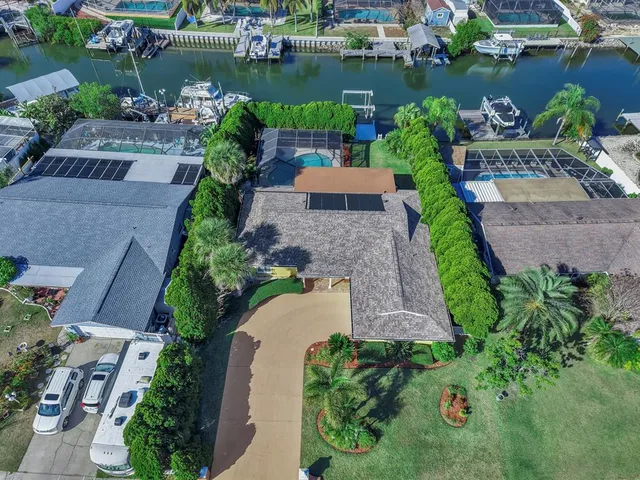 a kitchen with stainless steel appliances granite countertop a refrigerator a stove top oven with a dining table and chairs