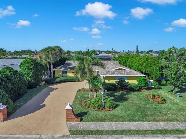 a living room with furniture kitchen view and a chandelier