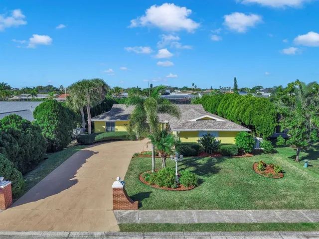 a living room with furniture kitchen view and a chandelier