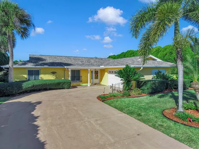 a kitchen with stainless steel appliances granite countertop a refrigerator sink and stove