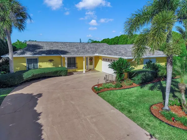a kitchen with granite countertop a refrigerator and a stove top oven