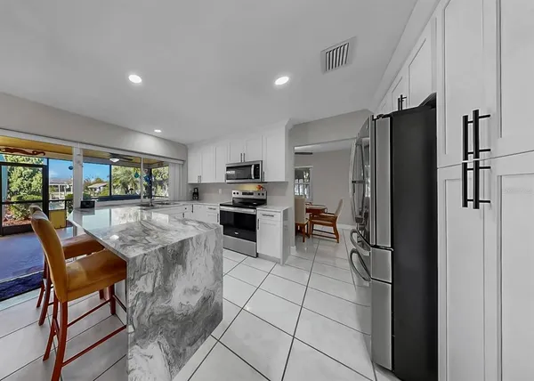 a kitchen with stainless steel appliances a sink stove and microwave