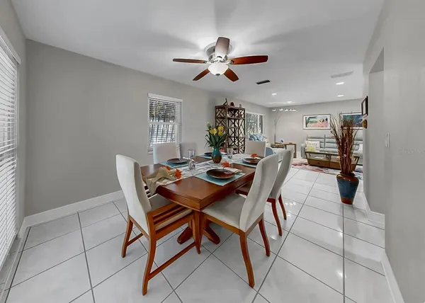 a spacious bathroom with a tub shower and mirror
