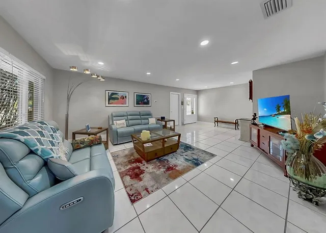 a bedroom with a bed and a lamp with the dresser