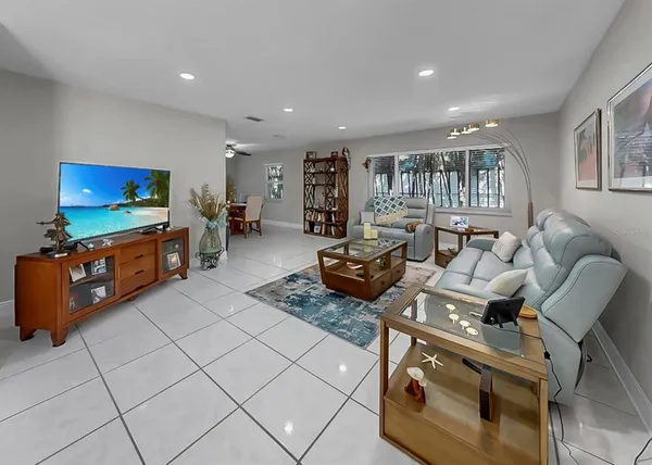 a view of a livingroom with furniture and a window