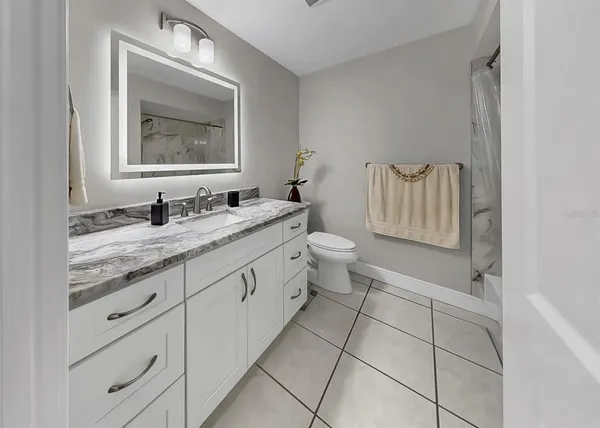 a view of a patio with table and chairs under an umbrella