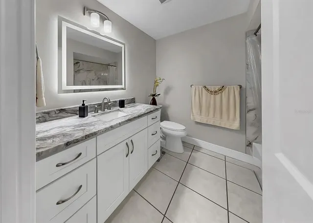 a view of a patio with table and chairs under an umbrella