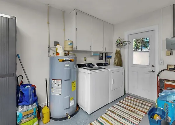 a view of a garden with a bench under an umbrella
