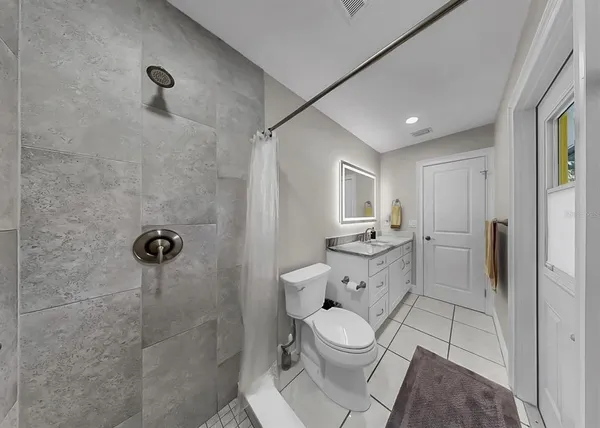 a view of a house with a yard and potted plants