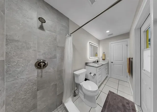 a view of a house with a yard and potted plants