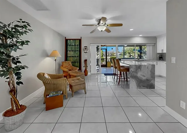 a view of a house with a yard and palm trees