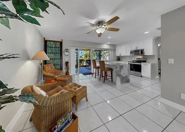 a living room with furniture and a potted plant