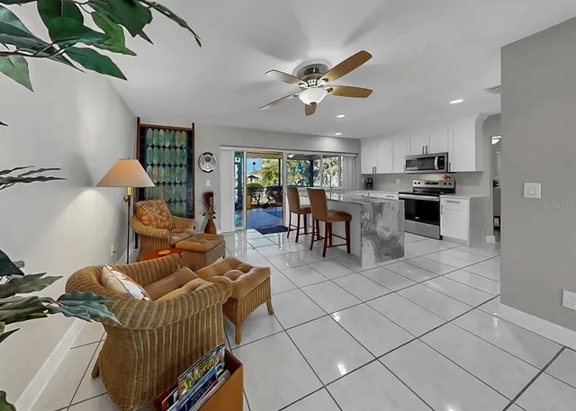 a living room with furniture and a potted plant