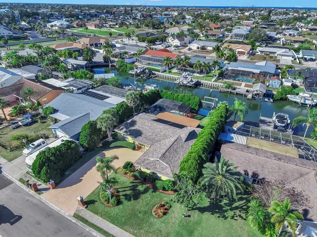 an aerial view of a city with lots of residential buildings and mountain view in back
