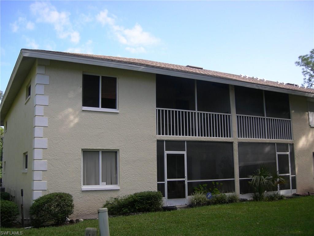3491 County Barn Road, Unit E201 Naples, FL 34112 - Photo 13 of 15 a front view of a house with garden
