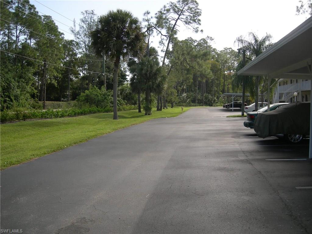 3491 County Barn Road, Unit E201 Naples, FL 34112 - Photo 14 of 15 a view of a backyard with sitting area