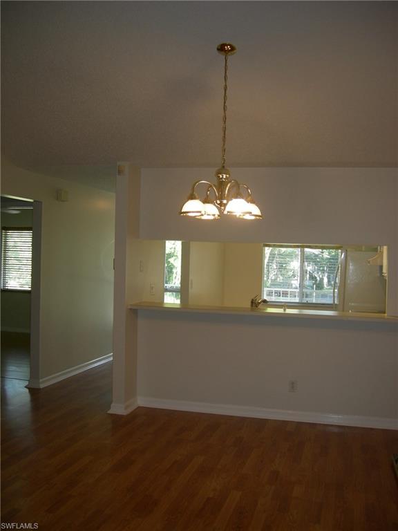 3491 County Barn Road, Unit E201 Naples, FL 34112 - Photo 2 of 15 a view of a room with a chandelier