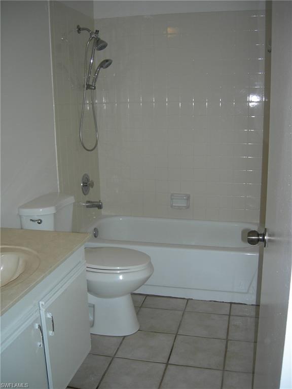 3491 County Barn Road, Unit E201 Naples, FL 34112 - Photo 9 of 15 a bathroom with a sink a toilet and shower