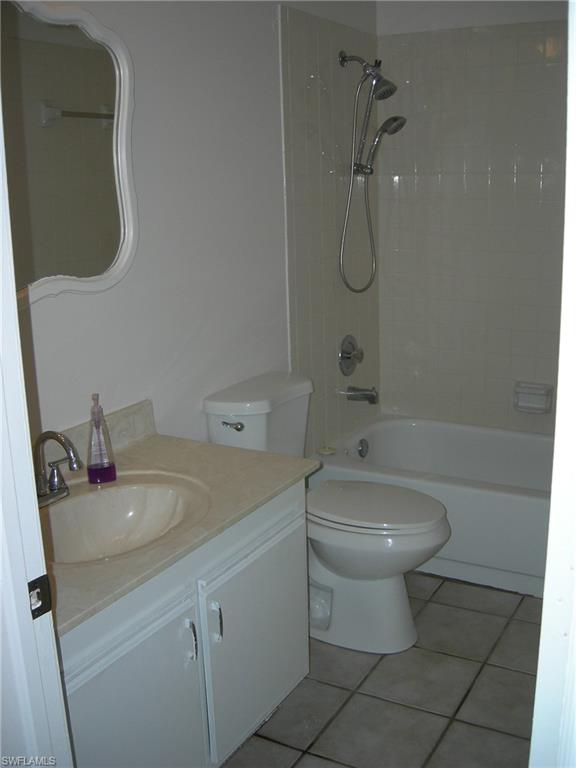 3491 County Barn Road, Unit E201 Naples, FL 34112 - Photo 10 of 15 a bathroom with a sink a toilet and shower