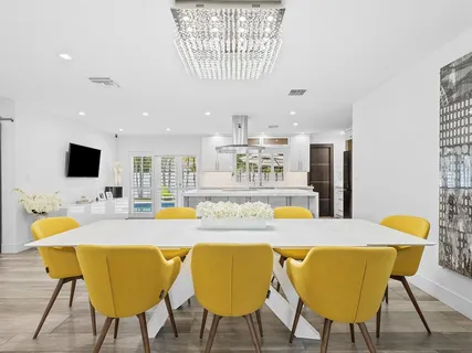 a dining room with furniture and wooden floor