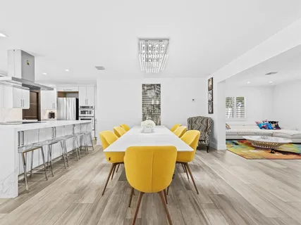 a kitchen with stainless steel appliances kitchen island granite countertop a refrigerator and a stove