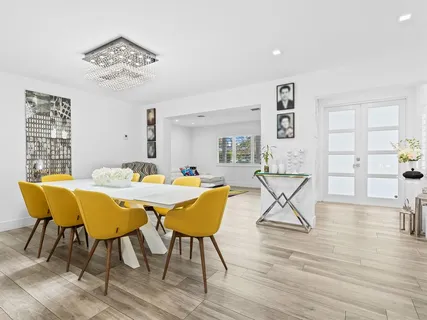 a kitchen with granite countertop a refrigerator oven a sink and dishwasher