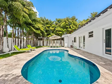 a backyard of a house with table and chairs