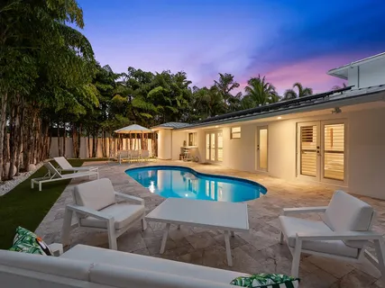a bathroom with a toilet sink vanity and mirror