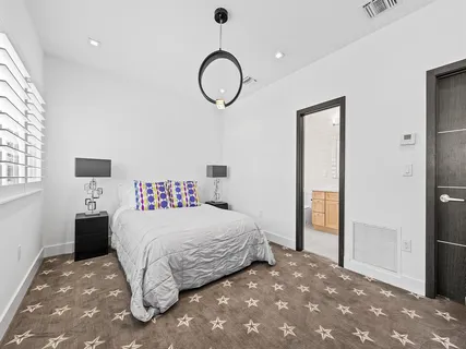 a bedroom with a large bed and a ceiling fan