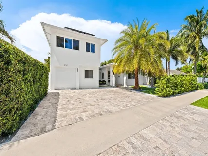 a house with palm tree in front of it