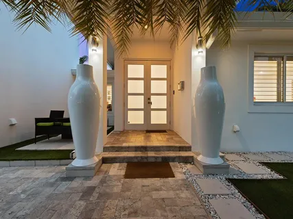 a hallway with wooden floor table and chairs