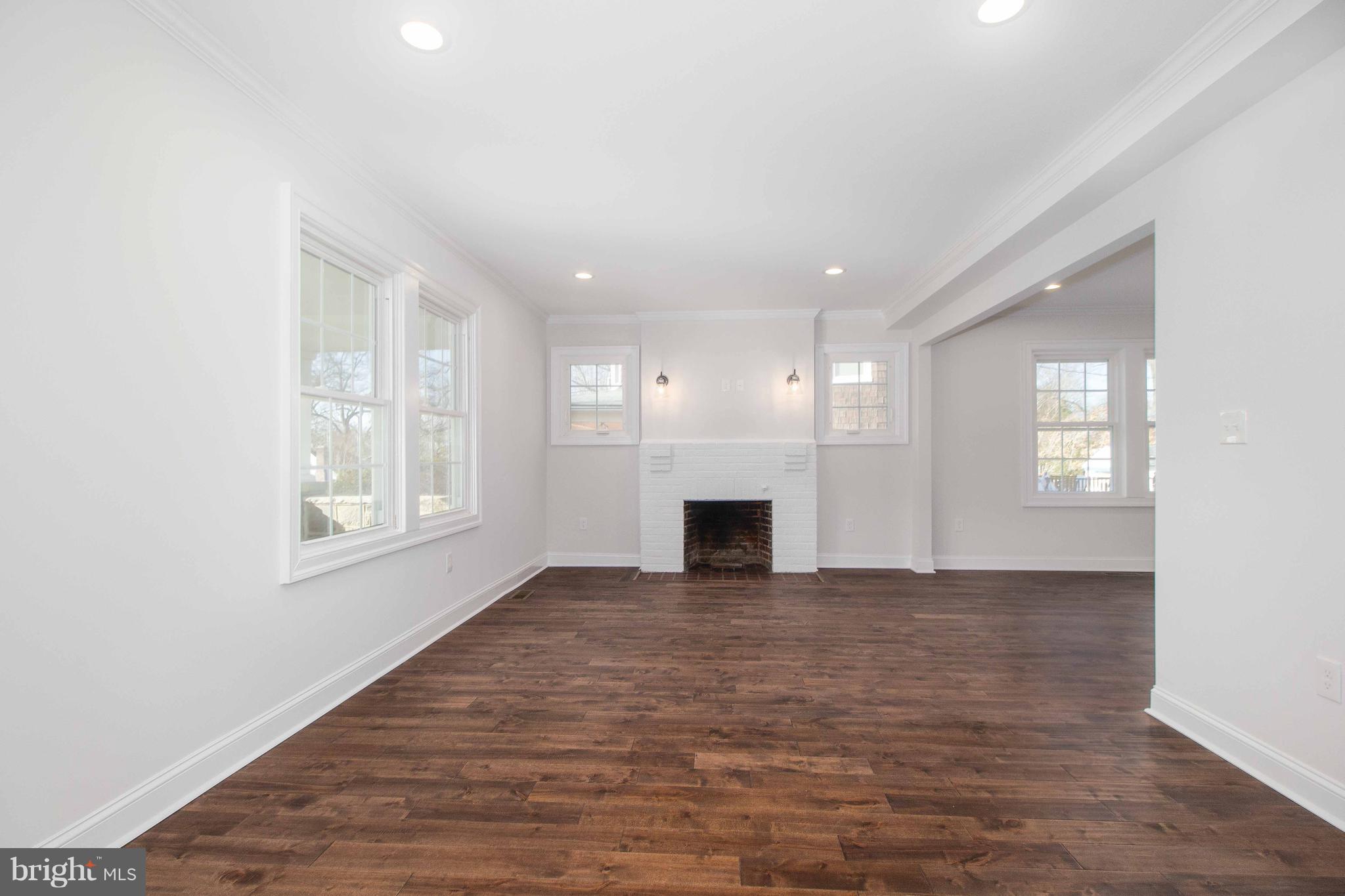 701 Brookwood Road Baltimore, MD 21229 - Photo 7 of 57 a view of an empty room with a window and fireplace