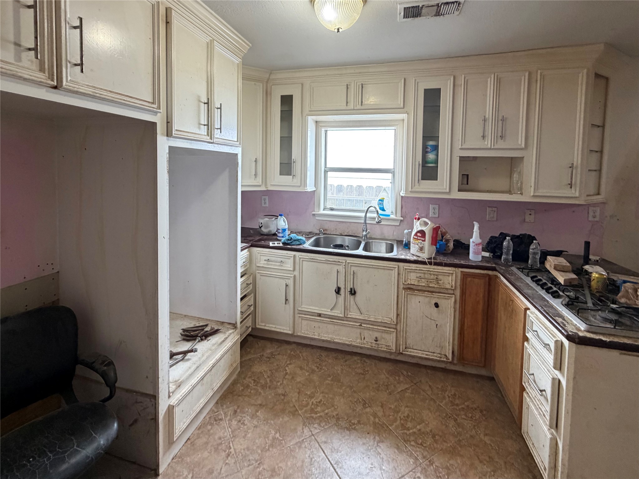 3508 Omega Street Houston, TX 77022 - Photo 9 of 15 a kitchen with granite countertop a sink and cabinets