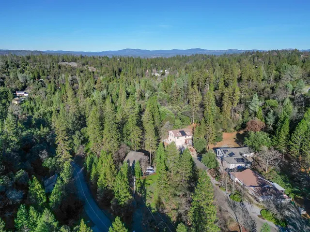 an aerial view of a residential houses with outdoor space