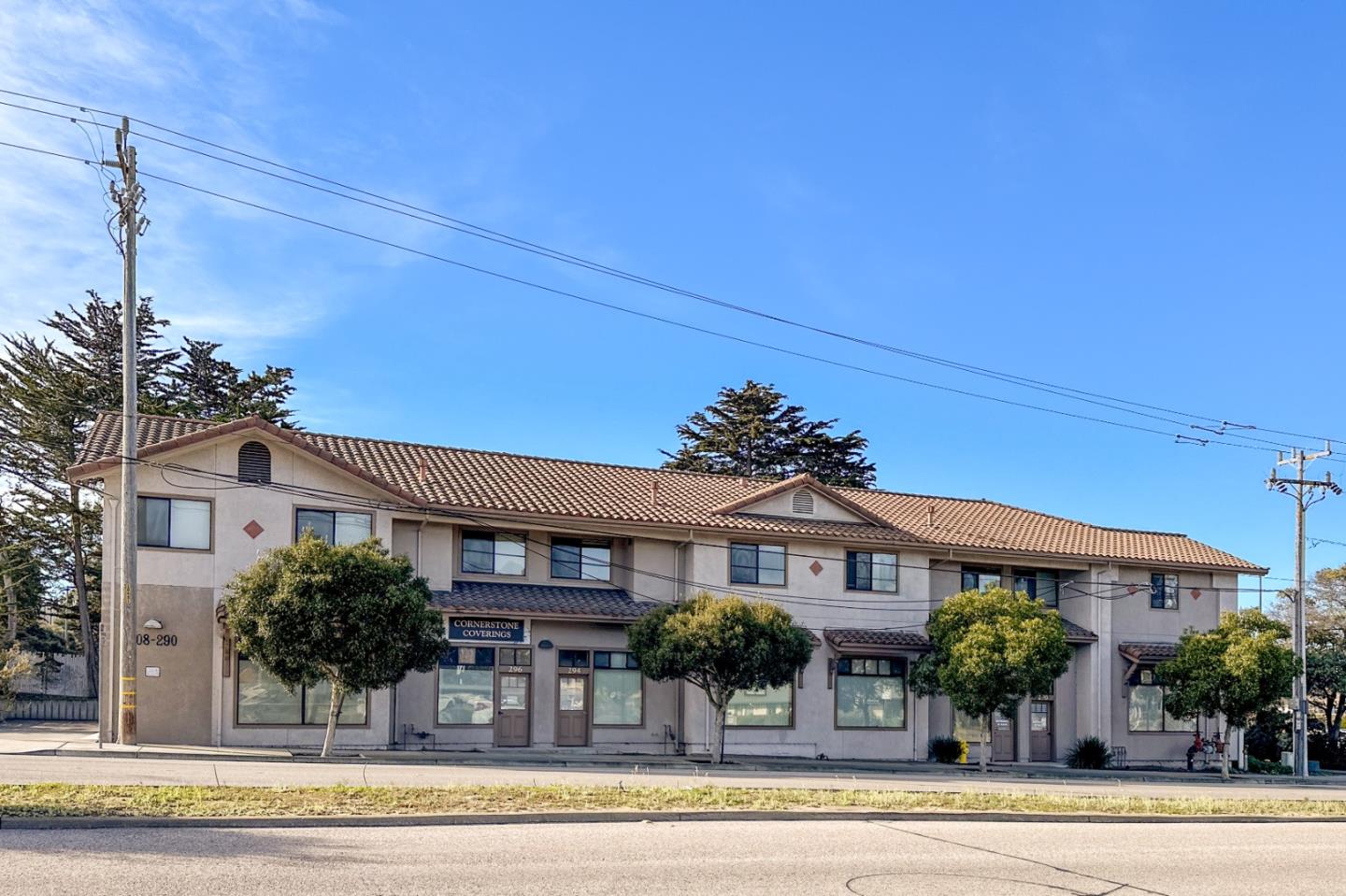 front view of a brick house with a yard