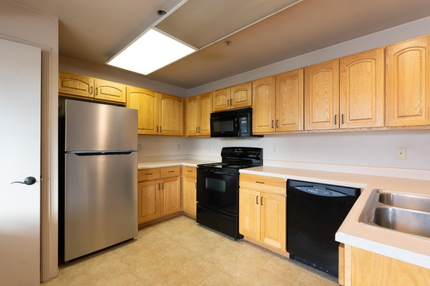306 Reservation Road Marina, CA 93933 - Photo 8 of 23 a kitchen with a refrigerator sink and microwave