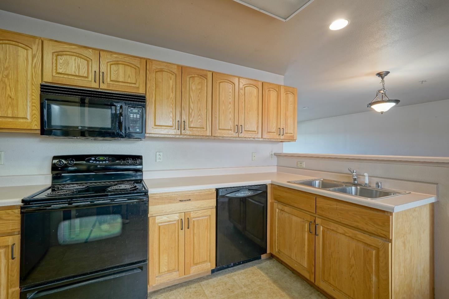 306 Reservation Road Marina, CA 93933 - Photo 10 of 23 a kitchen with cabinets stainless steel appliances and a window