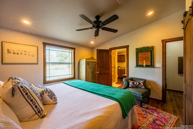 a bedroom with a bed and a mirror